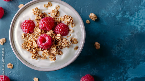 Overhead View of Creamy Yogurt with Granola and Raspberries in a Bowl