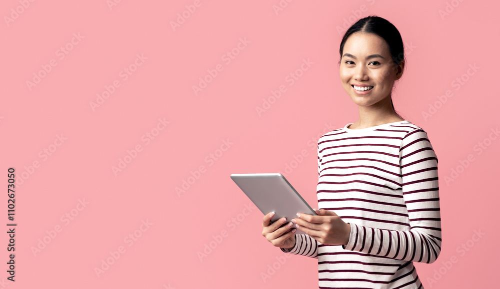 Modern Technologies For Leisure. Portrait Of Young Asian Female Using Digital Tablet And Smiling At Camera, Happy Korean Woman With Modern Device In Hands Posing Over Pink Background, Copy Space Modern Technologies For Leisure. Portrait Of Young Asian Female Using Digital Tablet And Smiling At Camera, Happy Korean Woman With Modern Device In Hands Posing Over Pink Background, Copy Space