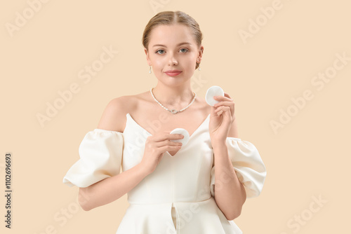 Young woman with cotton pad...