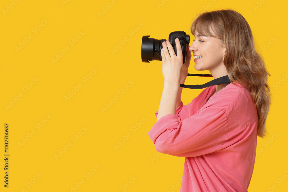 Beautiful young woman taking photo with modern camera on yellow background Beautiful young woman taking photo with modern camera on yellow background