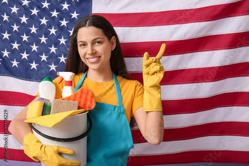 Female janitor holding buck...