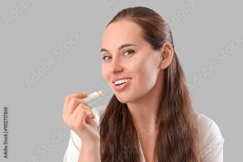 Young woman with lip balm o...