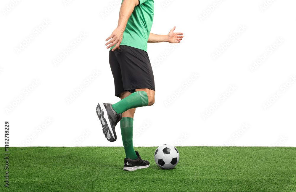 Obraz premium Man playing football with soccer ball on artificial grass against white background, closeup