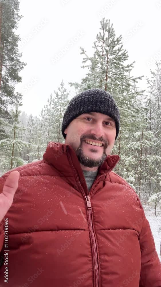 4k, Individual stands in a snowy forest, waving cheerfully. Surrounding trees are covered in white snow, creating a tranquil winter atmosphere. 4k, Individual stands in a snowy forest, waving cheerfully. Surrounding trees are covered in white snow, creating a tranquil winter atmosphere.