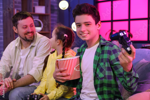 Little boy with popcorn and...