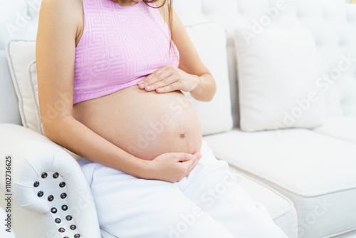 Asian pregnant woman relaxing at home.