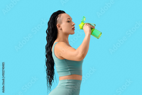 Young woman drinking water ...