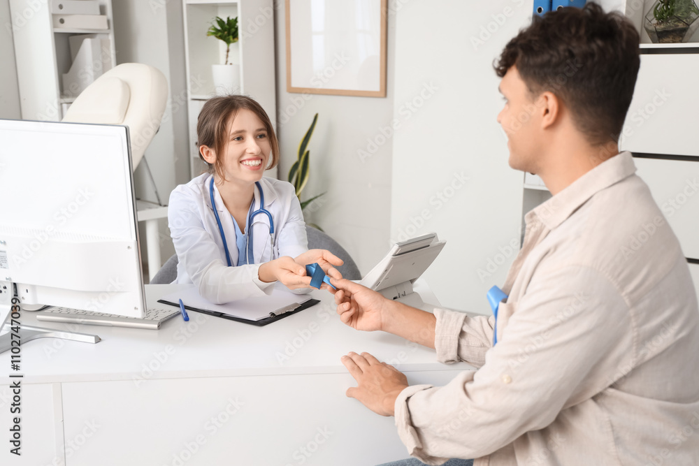 Female doctor and male patient with blue ribbon in clinic. Prostate cancer awareness concept Female doctor and male patient with blue ribbon in clinic. Prostate cancer awareness concept