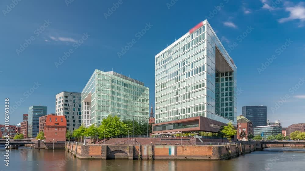 Timelapse of Hamburg HafenCity skyline at Ericusgraben with a view of modern Spiegel office buildings leading to St. Catherine's Church. Vibrant urban architecture by the Elbe in Germany Timelapse of Hamburg HafenCity skyline at Ericusgraben with a view of modern Spiegel office buildings leading to St. Catherine's Church. Vibrant urban architecture by the Elbe in Germany