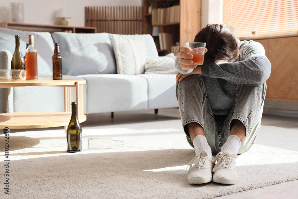 Drunk man with glass of whiskey at home. Alcoholism concept Drunk man with glass of whiskey at home. Alcoholism concept
