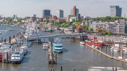 Jan Fedder Promenade aerial timelapse in Hamburg, Germany, a vibrant waterfront area. Ships and boats in marina on the Elbe River with famous buildings in background. Relaxation and scenic beauty photo