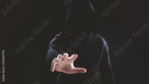 Foto Man wearing dark color hood jacket reaching his hand toward to grab something