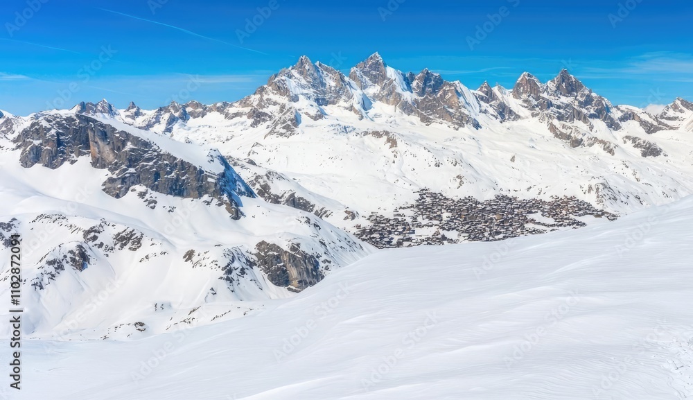 Alpine hiker trekking across snow-covered mountains with stunning blue sky. Alpine hiker trekking across snow-covered mountains with stunning blue sky.