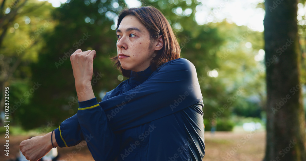 Naklejka premium Park, man and fitness with stretching as exercise routine for self care, wellness and health in Japan. Outdoor, male person and workout or training in sportswear with warm up, cardio and flexible
