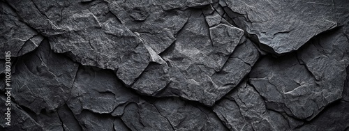 Close-up Rocky Surface Dark Gray Textured Background with Jagged Edges and Deep Crevices