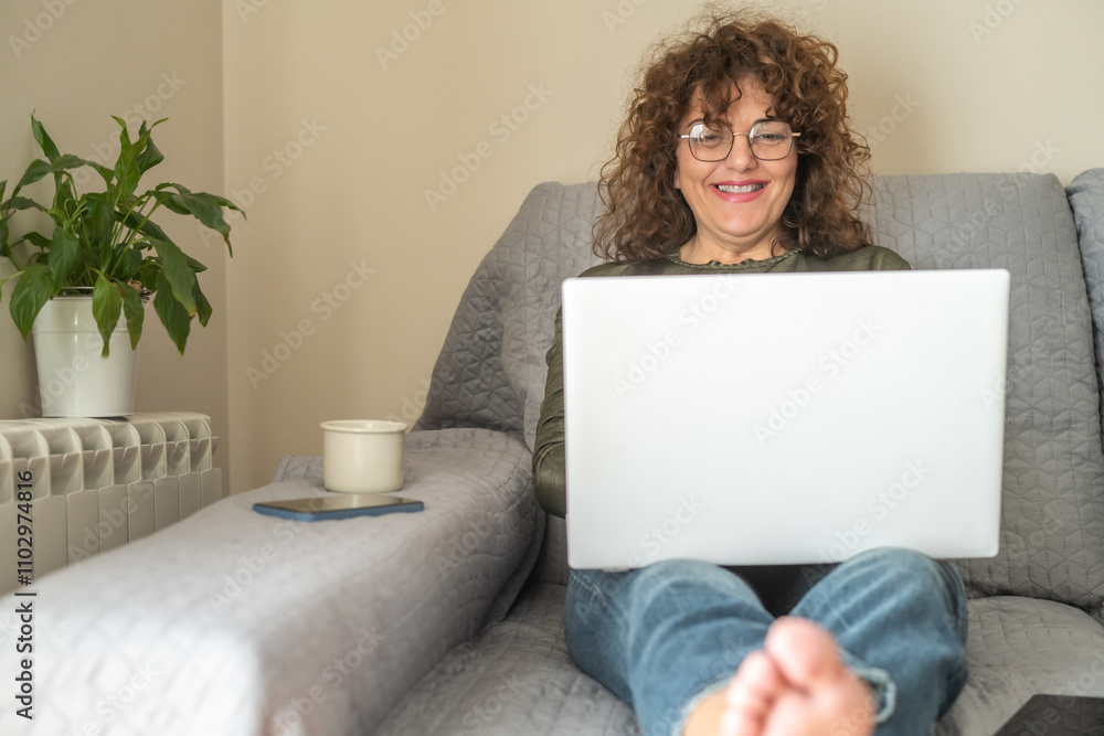Mature Woman Relaxing On Couch With Laptop, Smiling While Exploring Social Media, Indoor Technology Lifestyle, Happy Adult Lady Writing And Surfing Internet, Modern Leisure Concept At Home Mature Woman Relaxing On Couch With Laptop, Smiling While Exploring Social Media, Indoor Technology Lifestyle, Happy Adult Lady Writing And Surfing Internet, Modern Leisure Concept At Home