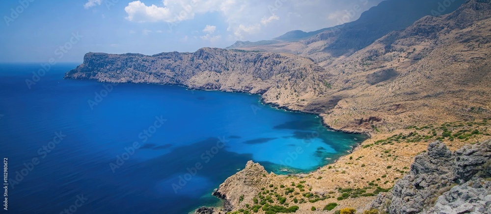 Stunning view of the wild Cretan countryside featuring rocky cliffs and crystal clear blue waters under a bright sky. Stunning view of the wild Cretan countryside featuring rocky cliffs and crystal clear blue waters under a bright sky.