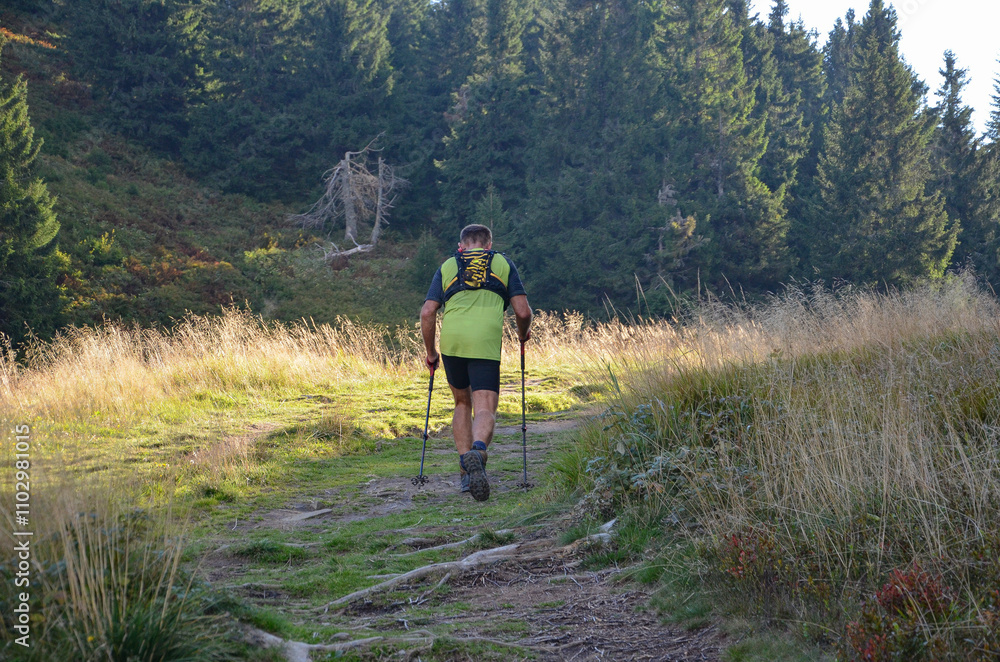 Backpacker on the trail from Korbielów to Pilsko Backpacker on the trail from Korbielów to Pilsko