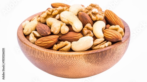 Walnuts filling a wooden bowl on a white table with green bokeh background