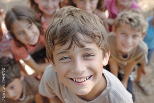 Portrait of smiling boy looking at camera with his friends in background