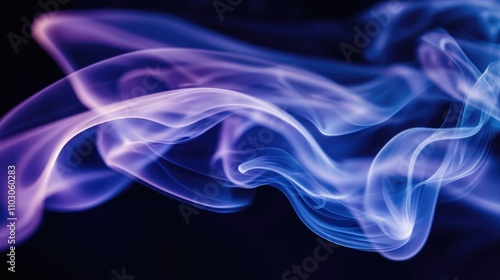 Vibrant swirling abstract smoke in rich blue and purple hues flowing gracefully against a dark backdrop, creating a mesmerizing visual effect.