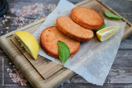  Fishburger.Homemade ketogenic  Salmon Burger with Tartar Sauce and  whole grain ketgenic bread. Healty  low carb high protein food photo