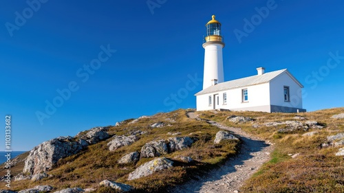 A lighthouselike house on a rocky hill, with a winding path leading up to its front door   lighthouse house, remote hilltop photo