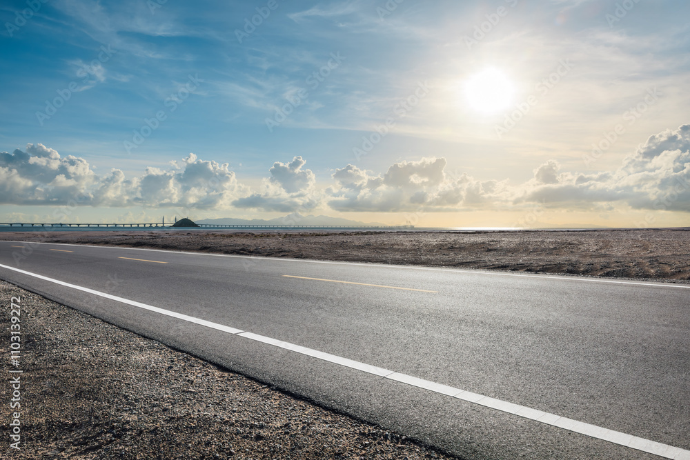 Asphalt highway road and coastline with sky clouds scenery. Outdoor road background. Asphalt highway road and coastline with sky clouds scenery. Outdoor road background.