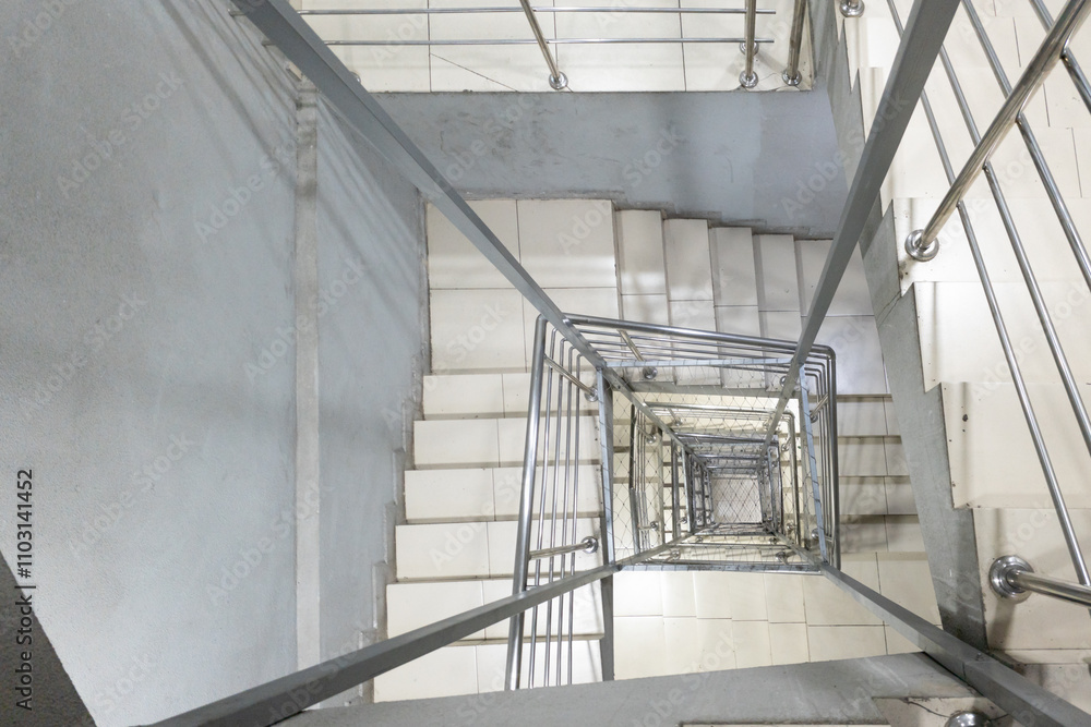 Fototapeta premium Generic square staircase shaft with steel net for fall safety