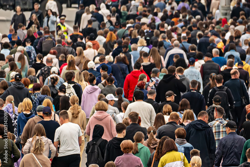 a background of unrecognizable people. Pandemonium in the metropolis. Overpopulation of the modern city. lots of people outside in the open air. A lot of urban residents have a rear view. photo