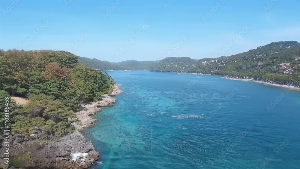 Aerial view of a serene coastal landscape with clear blue waters and lush greenery. Aerial view of a serene coastal landscape with clear blue waters and lush greenery.