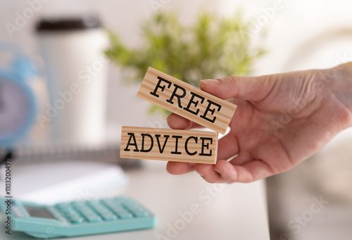 Free advice. A person holding a wooden block with the inscription Free advice. photo