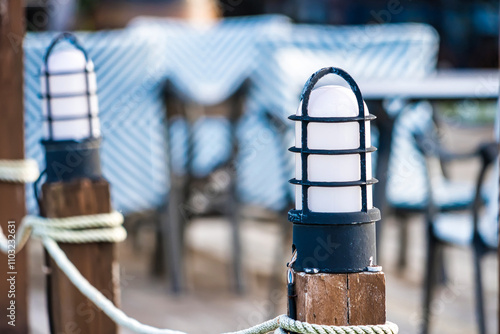 Charming Outdoor Café Lighting with Wooden Posts and Nautical Rope