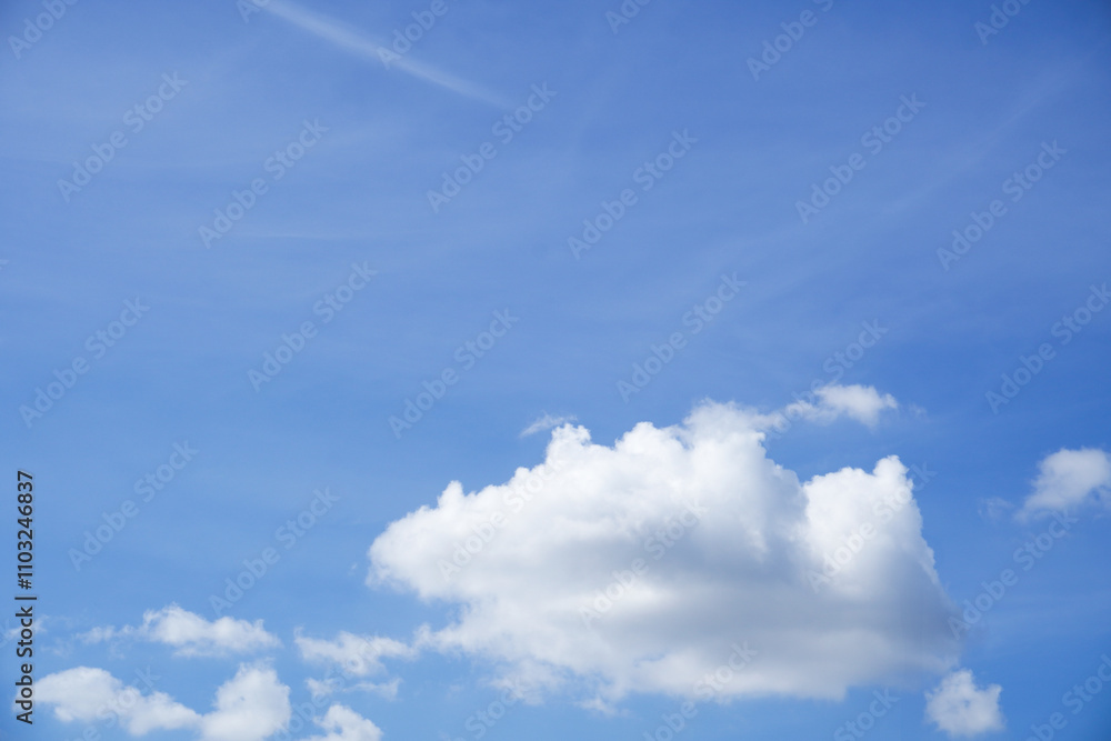 A single fluffy white cloud floats gracefully in a vibrant blue sky, creating a peaceful and minimalistic scene. Ideal for nature, weather, or serene background themes. A single fluffy white cloud floats gracefully in a vibrant blue sky, creating a peaceful and minimalistic scene. Ideal for nature, weather, or serene background themes.