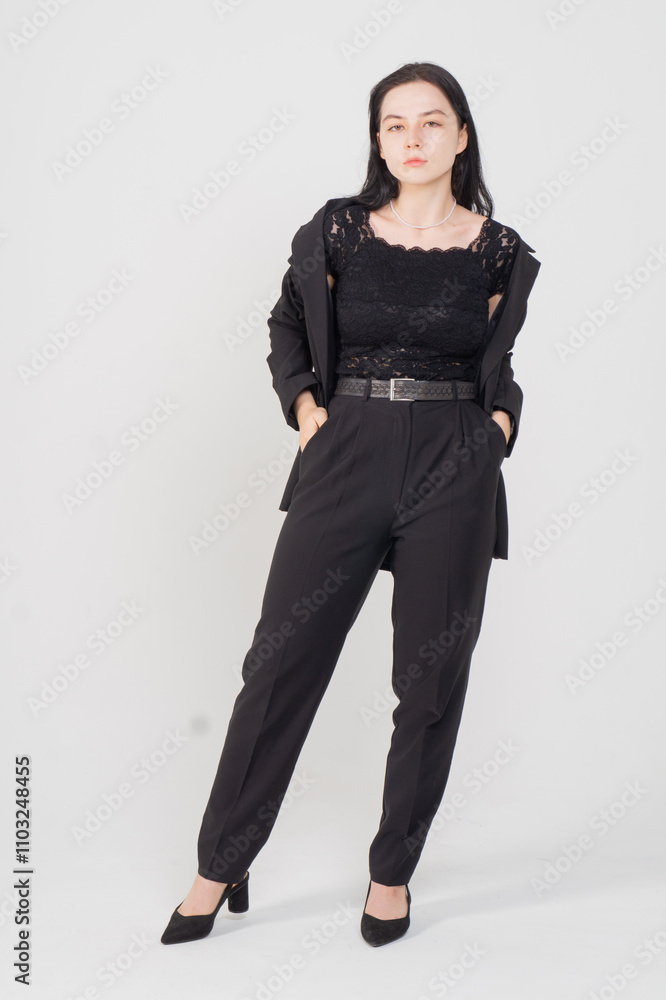 Cute young brunette standing on a white background. Copy space Cute young brunette standing on a white background. Copy space