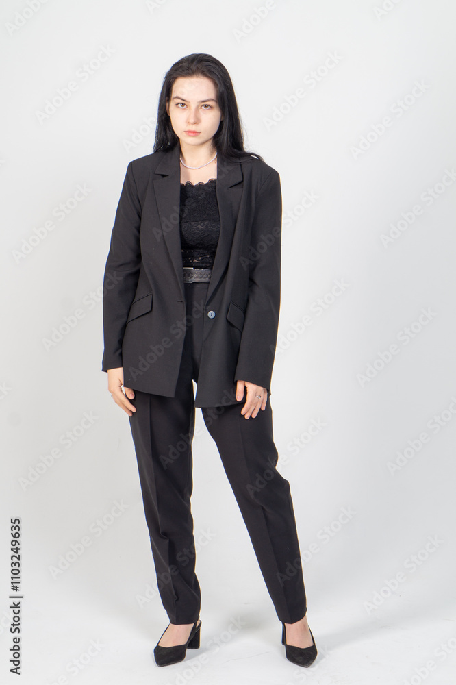 Cute young brunette standing on a white background. Copy space Cute young brunette standing on a white background. Copy space