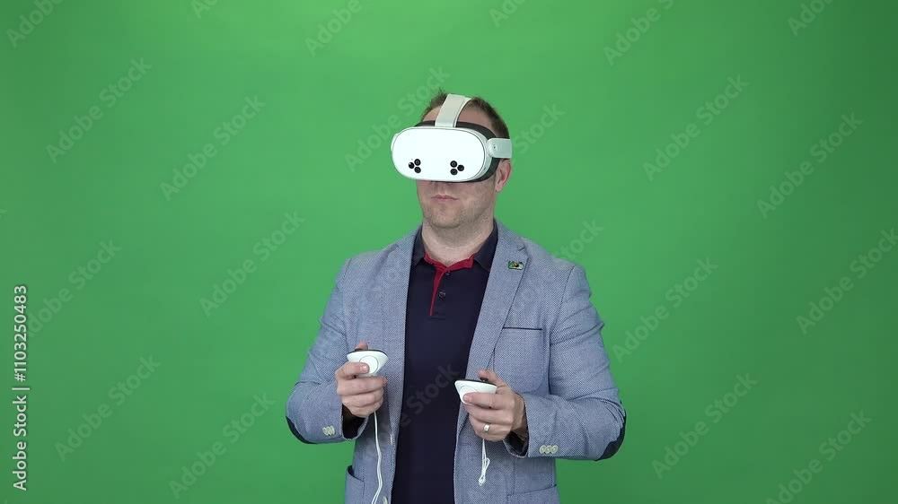 Young adult playing Meta Quest 3s. Green Screen background. Amazed by virtual reality. Young adult playing Meta Quest 3s. Green Screen background. Amazed by virtual reality.