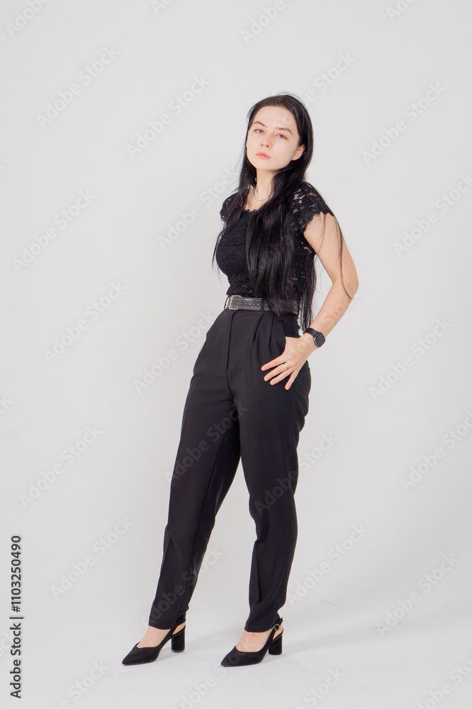 Cute young brunette standing on a white background. Copy space Cute young brunette standing on a white background. Copy space
