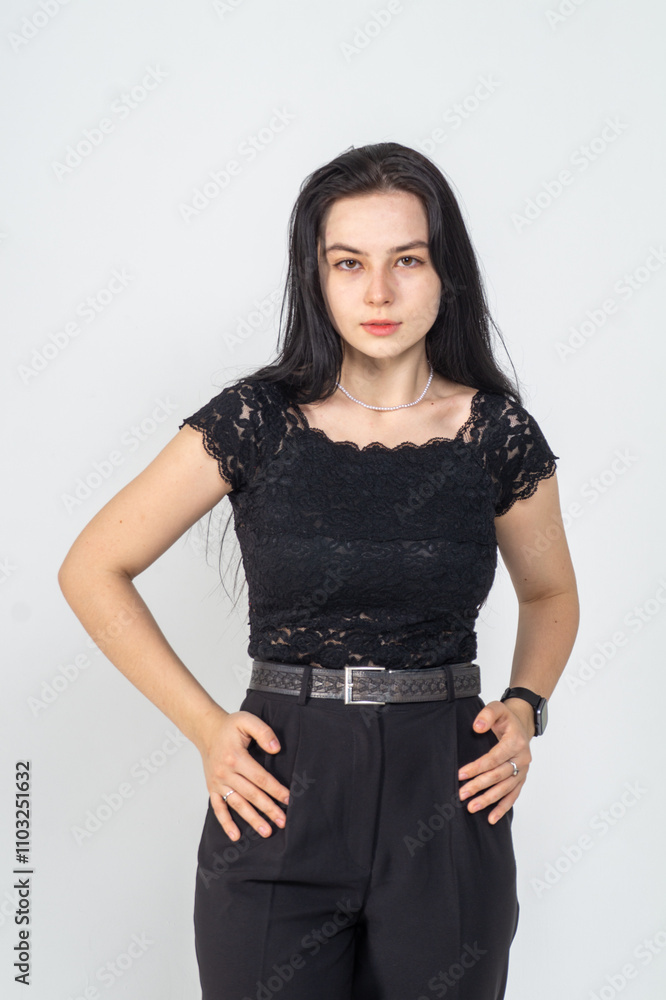 Cute young brunette girl standing on a white background. Copy space Cute young brunette girl standing on a white background. Copy space