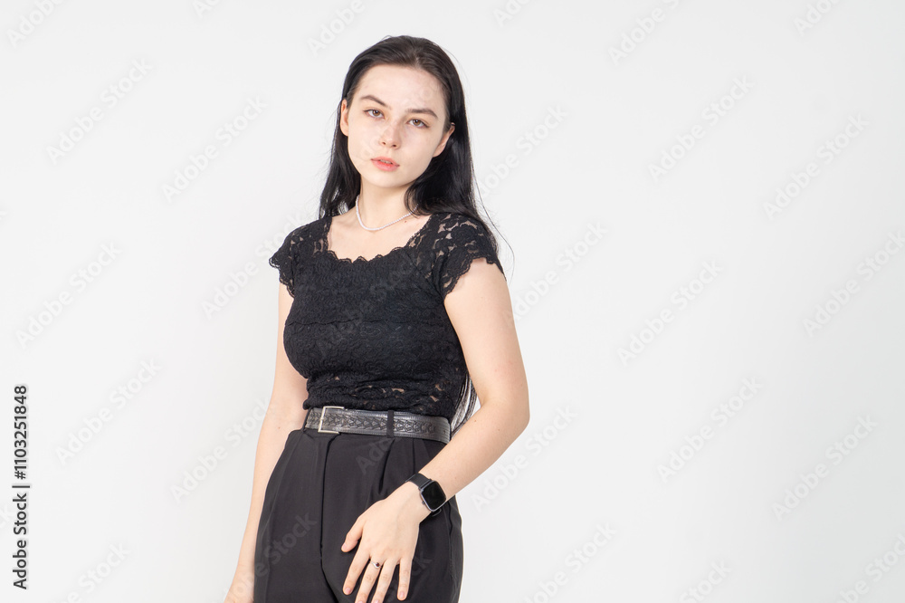 Cute young brunette girl standing on a white background. Copy space Cute young brunette girl standing on a white background. Copy space