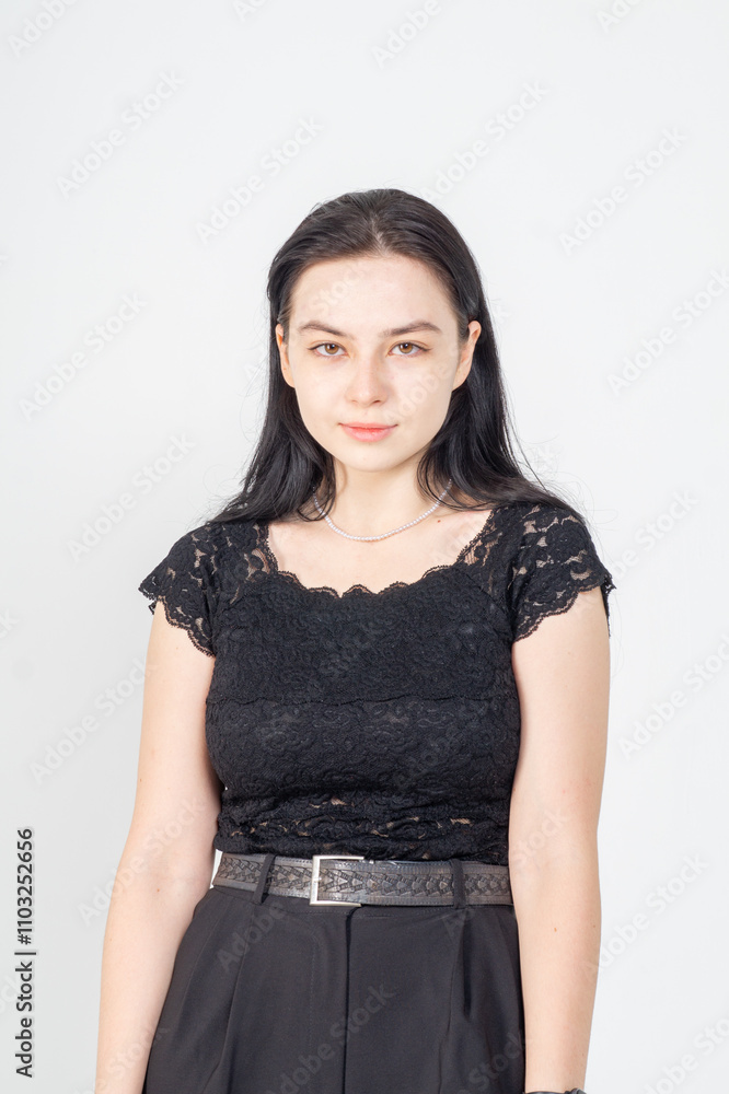 Cute young brunette girl standing on a white background. Copy space Cute young brunette girl standing on a white background. Copy space