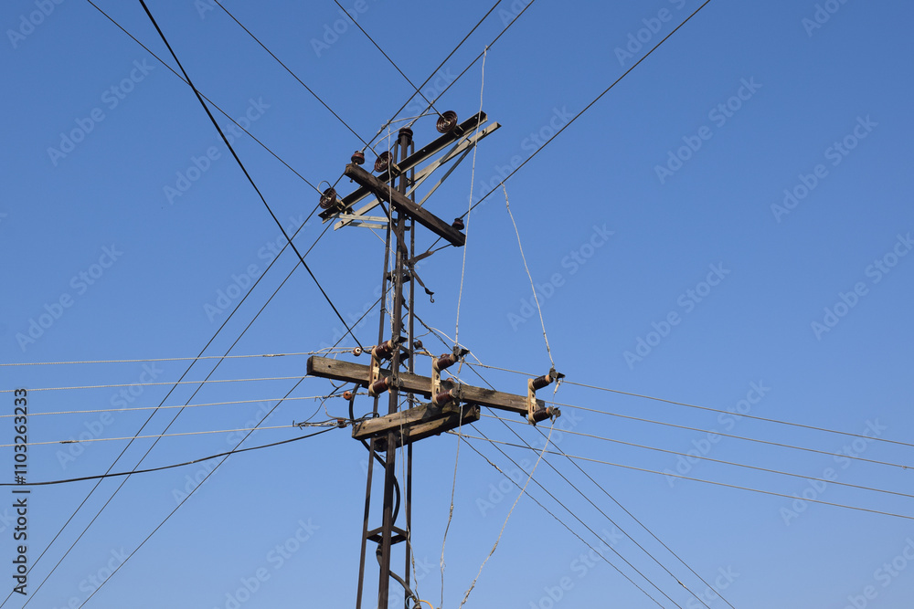 portrait of an electric substation with its cables stretching against a blue background, Pole-mounted transformer in Pakistan, 3-phase transformer in Czech Republic, Europe portrait of an electric substation with its cables stretching against a blue background, Pole-mounted transformer in Pakistan, 3-phase transformer in Czech Republic, Europe