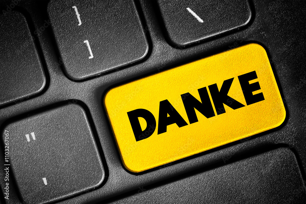 Fototapeta premium Danke (thank you in german) text button on keyboard, concept background