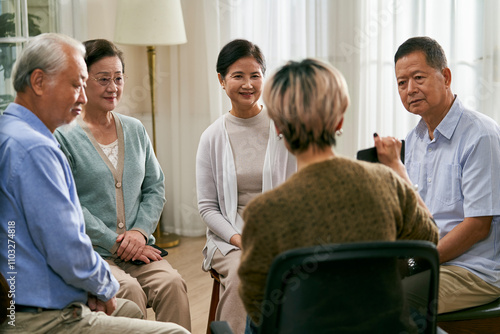 Photography asian counselor facilitating a group discussion for senior people