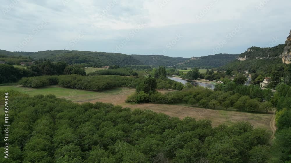 Drone aerial view in France countryside flying over a green mountain forest on a sunny day in La Roque Gageac Drone aerial view in France countryside flying over a green mountain forest on a sunny day in La Roque Gageac