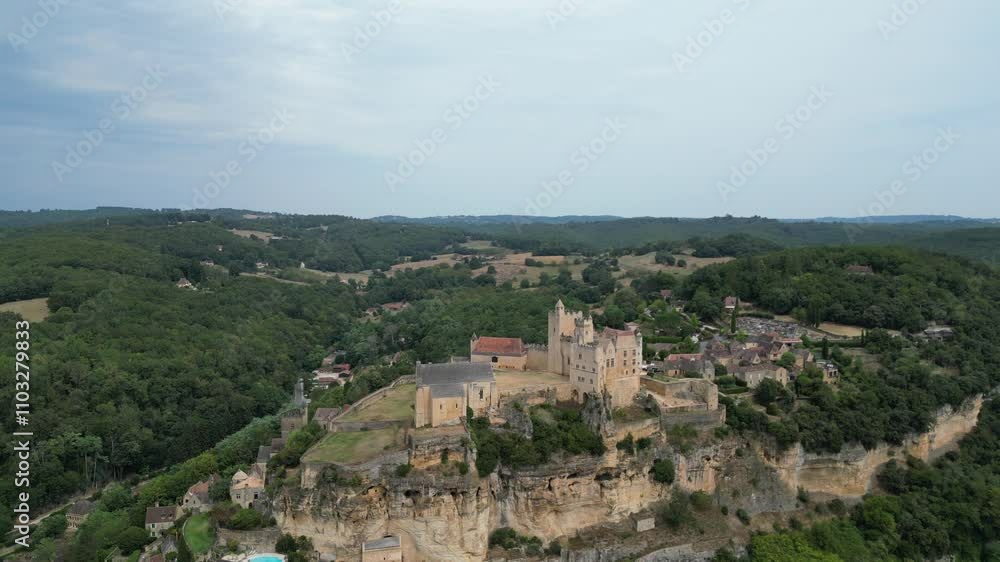 Drone aerial view in France countryside small old medieval town on a mountain top surrounded by a green forest with a castle in Beynac et Cazenac Drone aerial view in France countryside small old medieval town on a mountain top surrounded by a green forest with a castle in Beynac et Cazenac