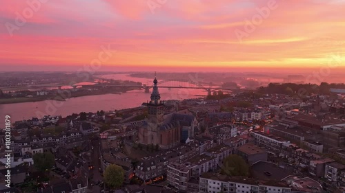 Aerial view of Nijmegen cityscape featuring the historic Stevenskerk and Waalbrug over the River Waal at sunrise, Gelderland, The Netherlands. photo