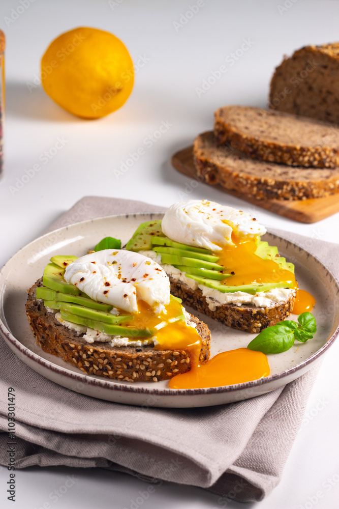 Two avocado open sandwiches with egg. Keto and diet concept. Healthy toast food for breakfast. Two avocado open sandwiches with egg. Keto and diet concept. Healthy toast food for breakfast.