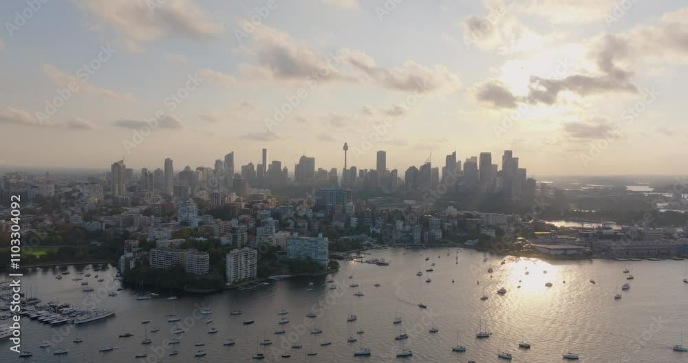 Aerial view of vibrant skyline and harbor with sailboats at sunset, Sydney, Australia. Aerial view of vibrant skyline and harbor with sailboats at sunset, Sydney, Australia.