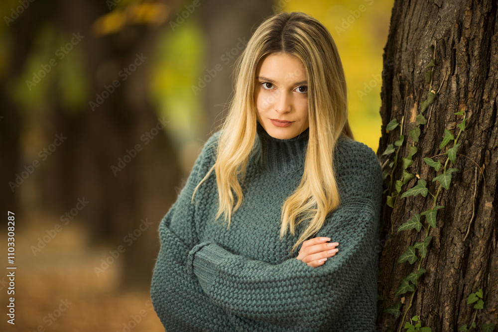 Portrait of beautiful blonde young woman in green sweater Portrait of beautiful blonde young woman in green sweater